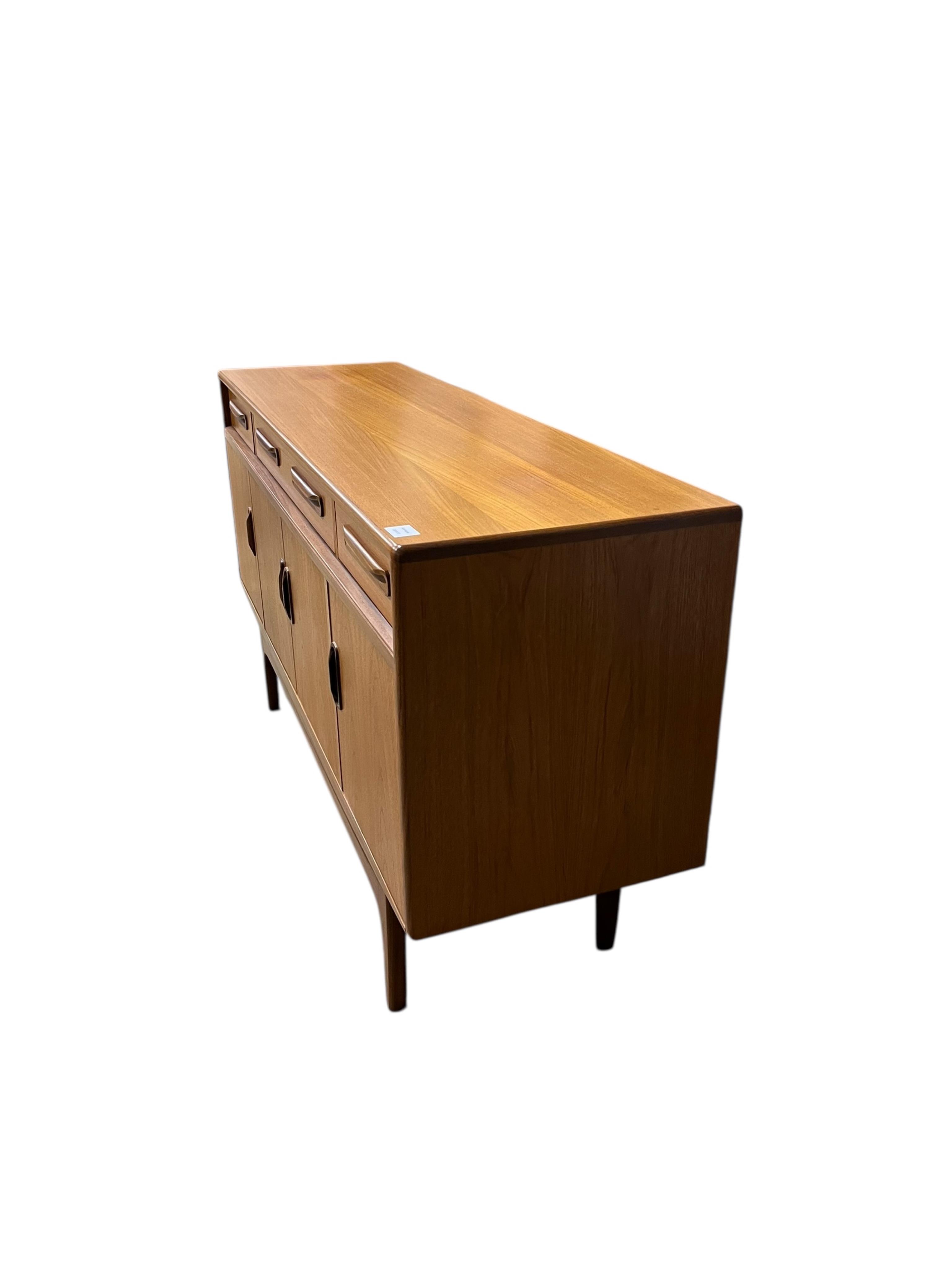 A mid century G Plan Fresco teak dining suite comprising dining table 184cm extended, depth 116cm, height 73cm, six chairs, two with arms and a four door sideboard, width 152cm